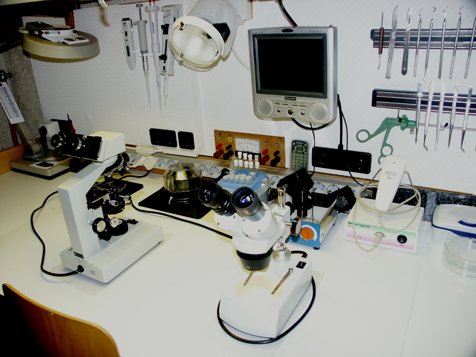 实验台上的显微镜、移液器与照明器具